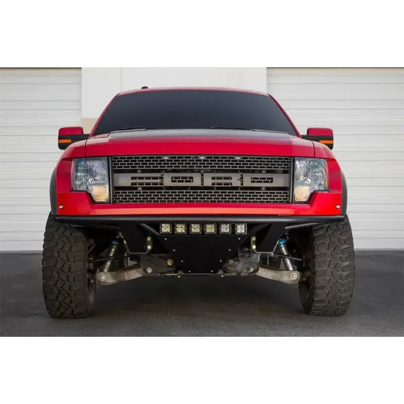 Red Ford Raptor pickup with Addictive Desert Designs ADD PRO front bumper