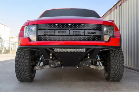 Red Ford Raptor off-road truck with Addictive Desert Designs ADD PRO Front Bumper