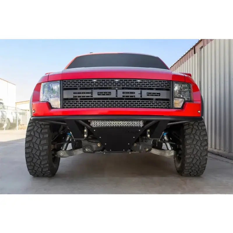 Red Ford Raptor off-road truck with Addictive Desert Designs ADD PRO Front Bumper
