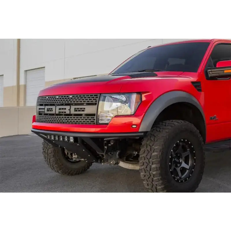 Red Ford Raptor truck with Addictive Desert Designs ADD PRO Front Bumper
