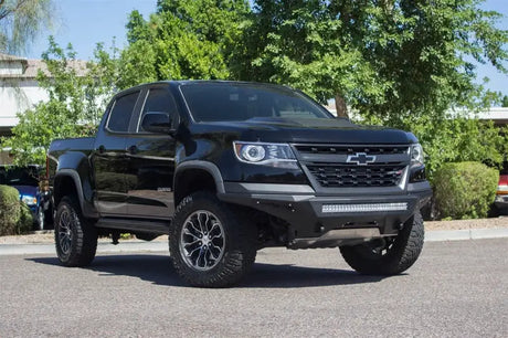Black Chevy Colorado with lifted suspension and LED lights featuring Addictive Desert Designs Stealth Fighter bumper