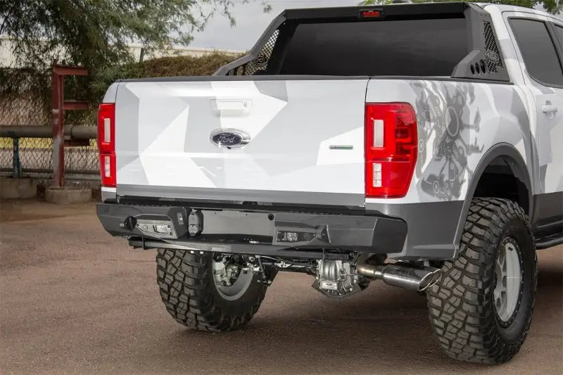Modified white Ford Ranger with Addictive Desert Designs stealth fighter rear bumper