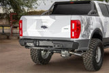 Modified white Ford Ranger with Addictive Desert Designs stealth fighter rear bumper