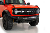 2021 Ford Bronco featuring the Addictive Desert Designs Stealth Fighter Front Bumper with Winch Mount, showcasing high clearance, hammer black powder coat finish, and integrated light bar.