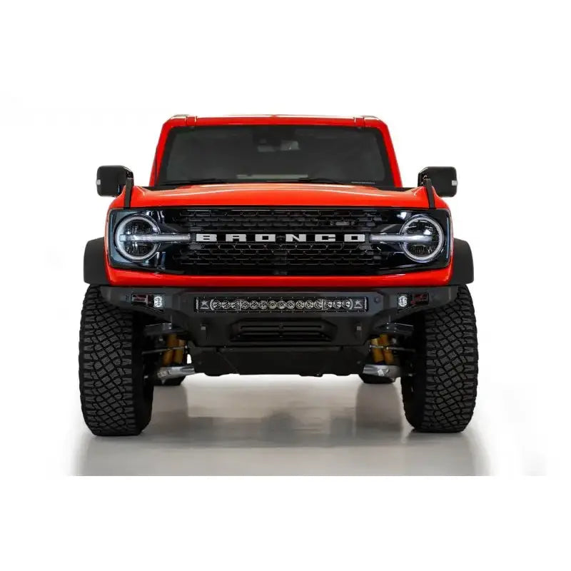 Addictive Desert Designs Stealth Fighter Front Bumper with Winch Mount on a 2021+ Ford Bronco, featuring a 30" light bar.
