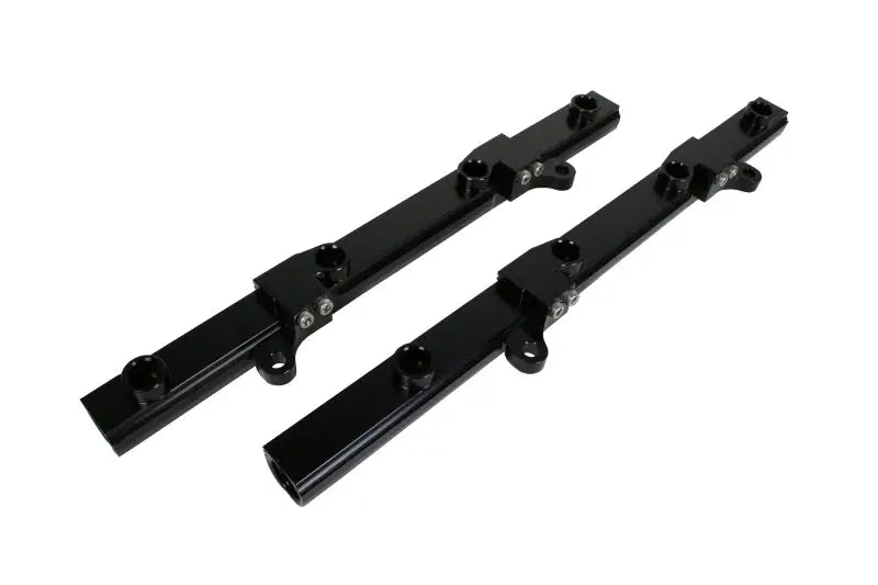 Image of two black Aeromotive fuel rails for Ford 5.0L 4V CJ16 engine