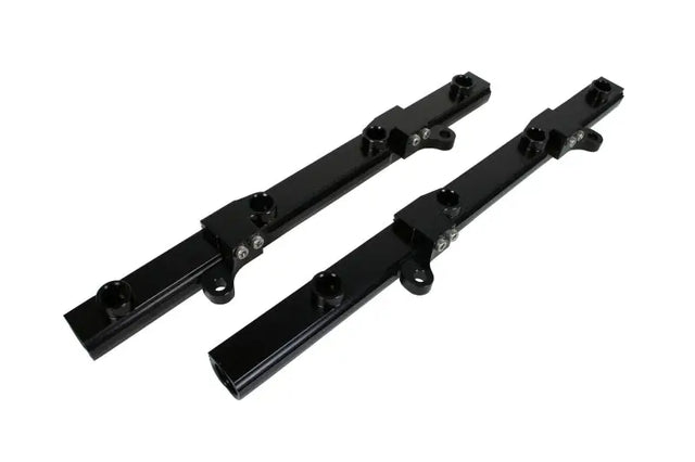 Image of two black Aeromotive fuel rails for Ford 5.0L 4V CJ16 engine