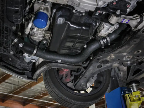 Car undercarriage with aftermarket charge pipe kit for Hyundai Veloster N in black