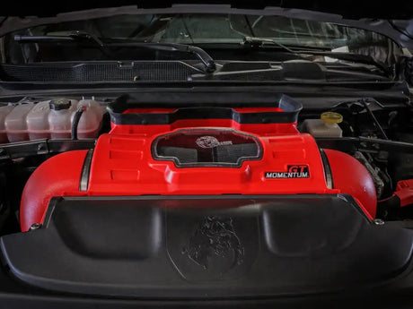 aFe Momentum GT Intake system installed in a Dodge RAM 1500 TRX V8-6.2L engine bay, featuring a vibrant red filter housing with a clear sight window.