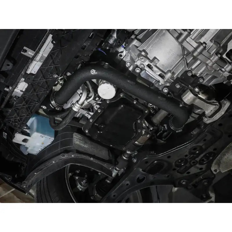Car engine underside with aFe BladeRunner hot charge pipe for Hyundai Elantra GT