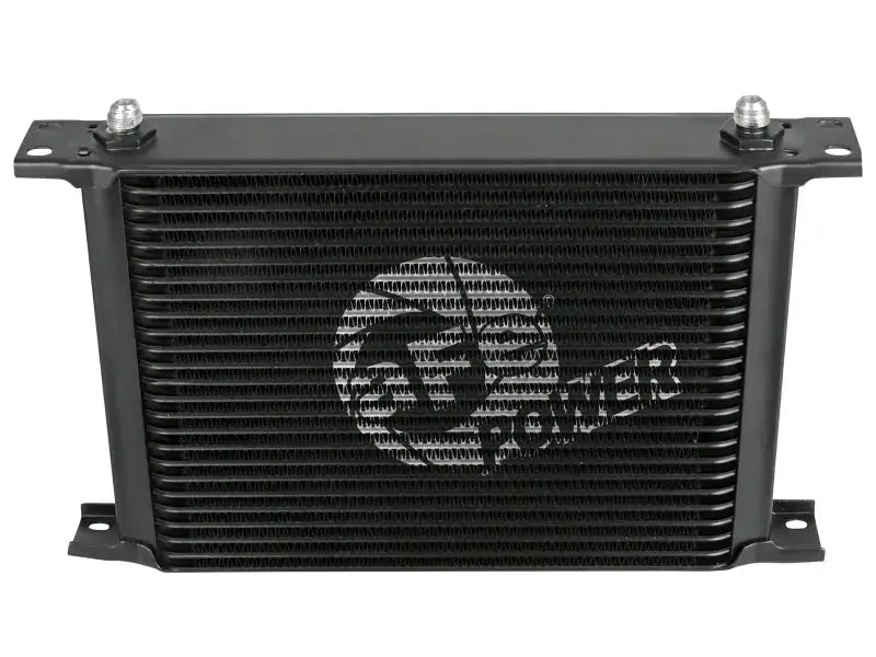 Black rectangular oil cooler from aFe Bladerunner auto transmission oil cooler kit for Silverado