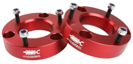 Pair of red aluminum suspension lift spacers with bolts for Ford F-150 leveling kit