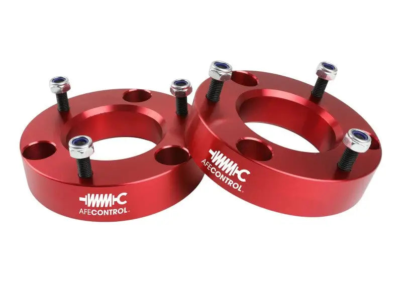 Red aluminum lift spacers with bolts for Ford F-150 leveling kit by aFe Control