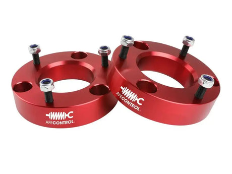Red aluminum lift spacers with bolts for Ford F-150 leveling kit by aFe Control