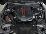 Car engine with red stripes showing aFe CONTROL suspension strut brace for Toyota GR Supra