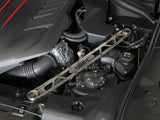 Metallic suspension strut brace installed in Toyota GR Supra engine bay for improved stability