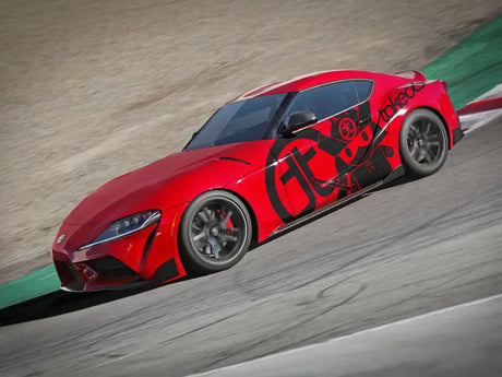 Red sports car with black decals showcasing aFe Control suspension package for Toyota Supra