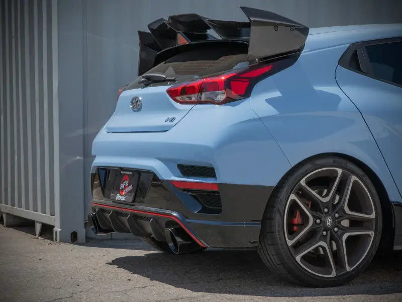 Light blue Hyundai Veloster N with large spoiler and Takeda Cat-Back Exhaust system