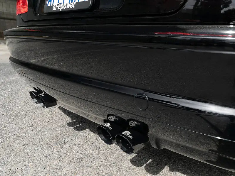 Black car’s exhaust pipes with stainless steel tips from aFe Mach ForceXP system on BMW M3