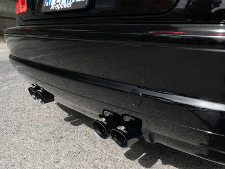 Black car’s exhaust pipes with stainless steel tips from aFe Mach ForceXP system on BMW M3