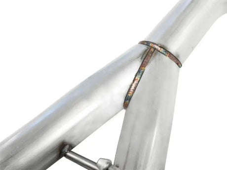 Welded metal pipe junction on aFe MachForce XP cat-back with polished dual tips