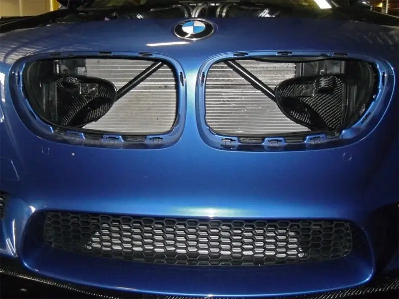 Blue BMW F10 M5 front end with exposed radiator showcasing afe magnum force intake system