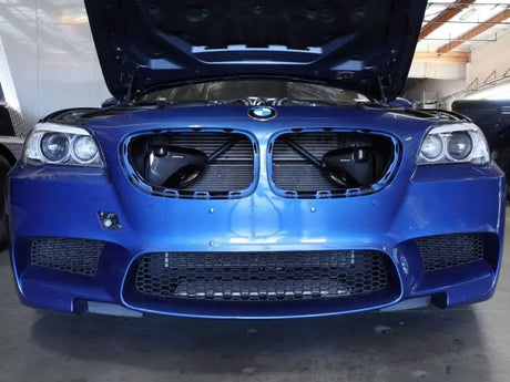 Blue BMW M5 with open hood showcasing aFe Magnum FORCE Intake System carbon fiber scoops