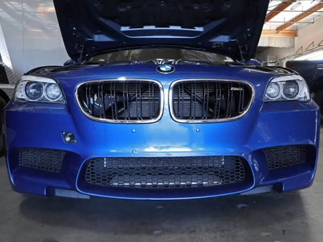 Blue BMW M5 with open hood showcasing aFe Magnum Force intake system and carbon fiber scoops