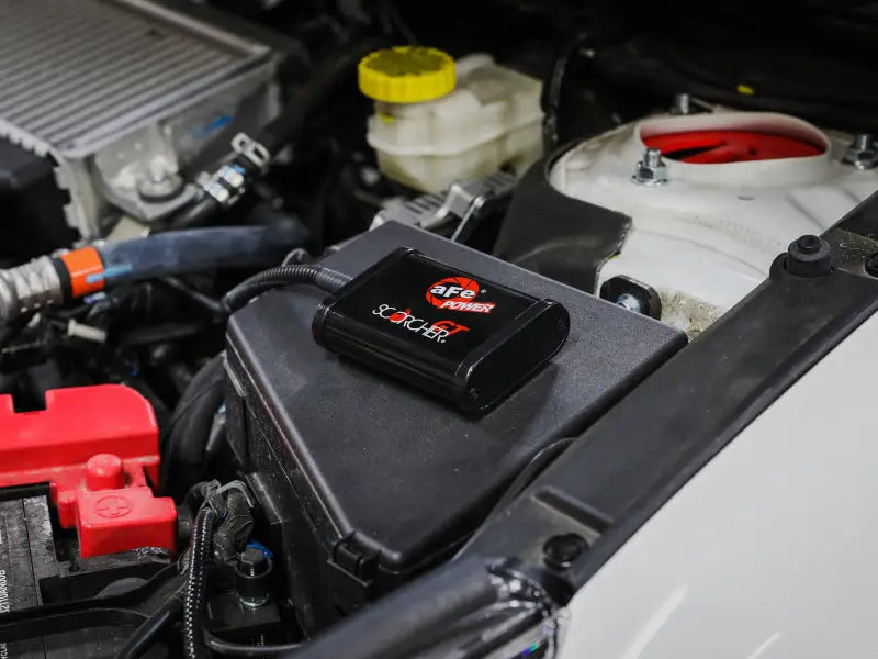 Black aFe Scorcher GT Module with red accents for Subaru Outback H4-2.4L engine boost