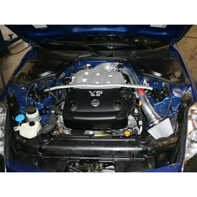 aFe Takeda Stage-2 PDS AIS polished cold air intake setup installed in Nissan 350Z 03-06 V6 engine bay.