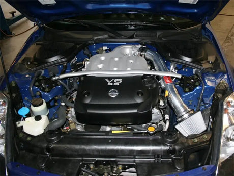 aFe Takeda Stage-2 PDS AIS polished cold air intake setup installed in Nissan 350Z 03-06 V6 engine bay.