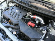 Car engine with aftermarket intake featuring afe takeda intakes on a Nissan Cube 09-12