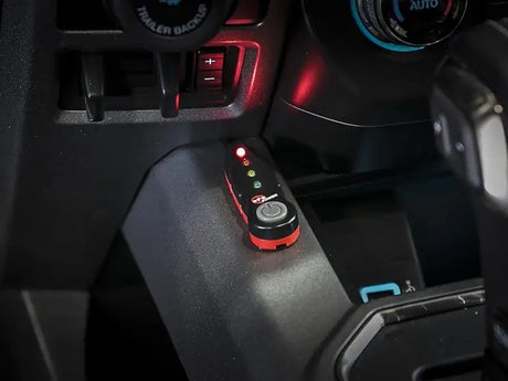Black and red remote control with illuminated lights for aScorcher GT modules in Toyota GR Corolla