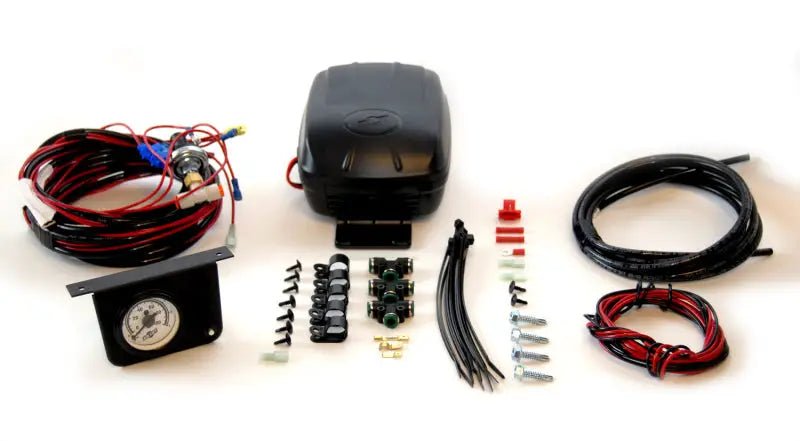 Air Lift Load Controller II - Single Gauge kit with LPS 5 PSI Min, showing the complete contents including compressor, wiring harness, gauge panel, and various installation components.