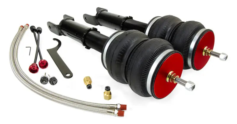 Air Lift Performance 2014+ Infiniti Q50 RWD/AWD Rear Kit components displayed, including threaded-body shocks, double-bellow air springs, rubber-isolated mounts, adjustable damping knobs, braided steel air lines, and installation tools.