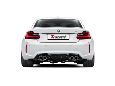 White BMW M2 with Akrapovic exhaust showcasing rear carbon fiber diffuser