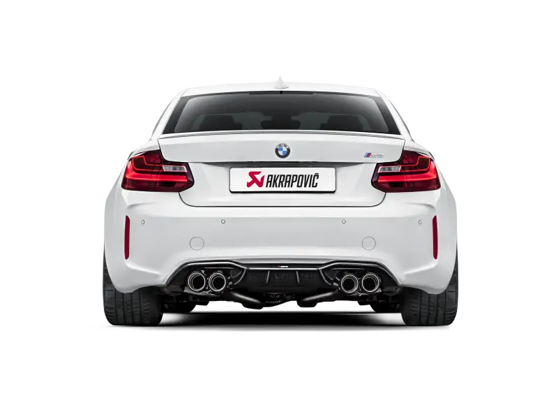 White BMW M2 with Akrapovic exhaust showcasing rear carbon fiber diffuser