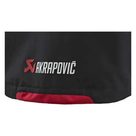 Akrapovic Womens Corpo Rain Jacket Black - M features a sleek design with a stylish logo for rainy day protection.