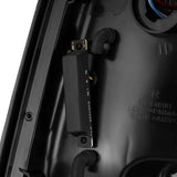 Close-up view of the AlphaRex 09-18 Dodge Ram 1500 PRO-Series LED Tail Lights in Jet Black, showing detailed components and wiring.