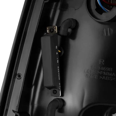 Close-up view of the AlphaRex 09-18 Dodge Ram 1500 PRO-Series LED Tail Lights in Jet Black, showing detailed components and wiring.