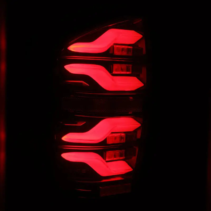 AlphaRex 16-21 Toyota Tacoma LUXX LED Taillights Blk/Red w/Activ Light/Seq Signal in dark background, high-quality LED technology for enhanced safety and visibility, stylish truck accessories, Lights, AVADA - Best Sellers