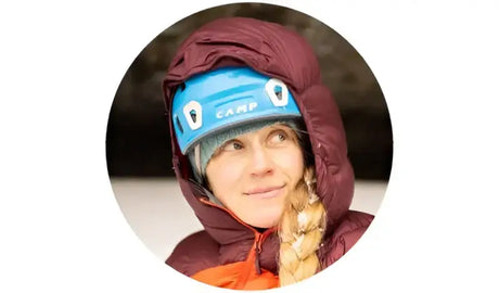 Climber with blue helmet and maroon jacket showing Answer 23 Ascent Glove Red/White/Blue