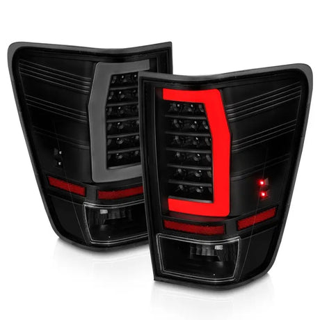 Smoked black LED tail lights with red accents for Nissan Titan in black housing and smoke lens