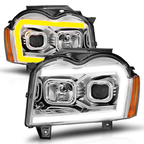 Two aftermarket Jeep Grand Cherokee projector headlights with LED light bar switchback in chrome