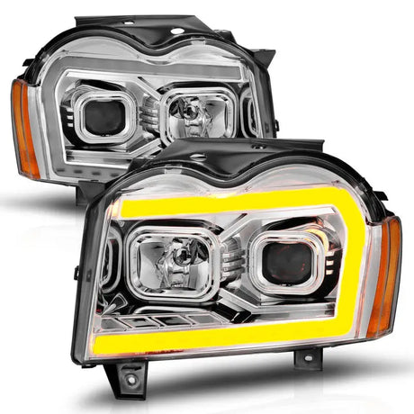 Two aftermarket Jeep Grand Cherokee headlights with LED light bar and switchback chrome housing