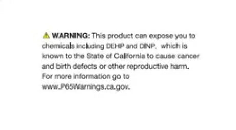 Warning label on ANZO Ford Mustang projector headlights with light bar showing chemical risks