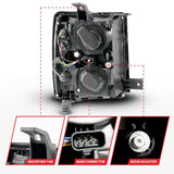 Rear view of Chevrolet Silverado projector headlights with black housing and mounting tabs
