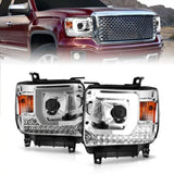 Red GMC Sierra with aftermarket LED headlights featuring plank style projector and chrome housing