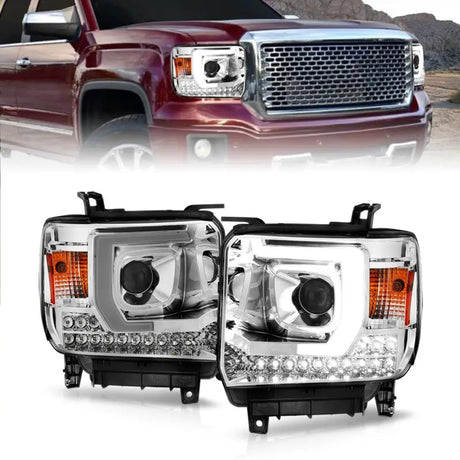 Red GMC Sierra with aftermarket LED headlights featuring plank style projector and chrome housing