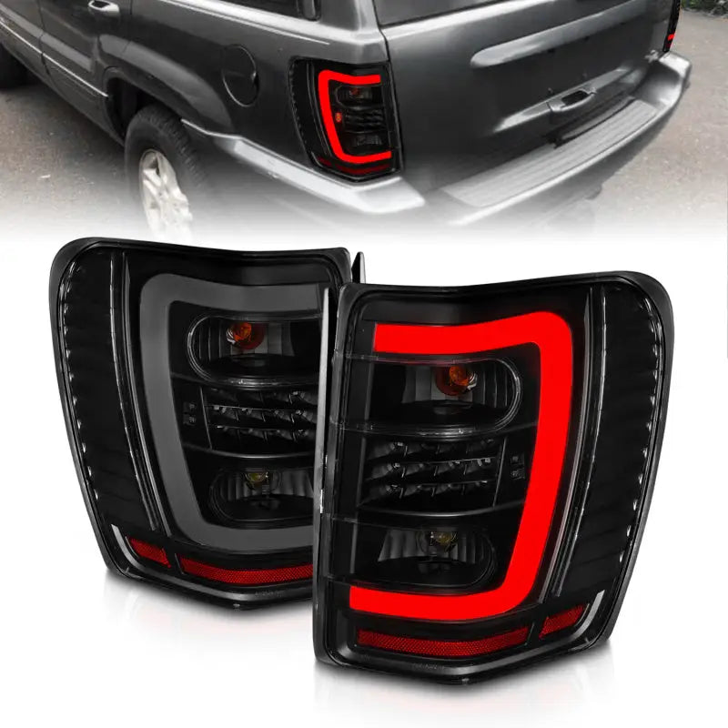 ANZO 1999-2004 Jeep Grand Cherokee LED Tail Lights w/ Light Bar Black Housing Smoke Lens - Truck & Automotive
